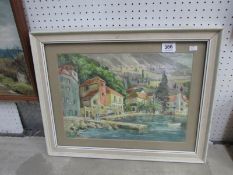 A framed seaside village watercolour