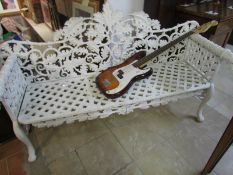 A cast iron bench with dog head arms