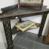 A carved oak corner table