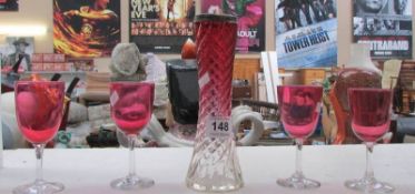 A cranberry glass vase with silver rim and 4 cranberry glasses