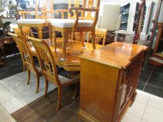 A superb quality extending dining table, 8 chairs and serving cabinet