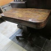 A rosewood fold-over card table