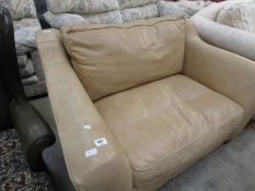 A 2 seat beige leather sofa