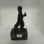 A bronze figure of a lamp boy on marble base