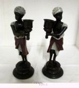 A pair of cold painted bronze 'Blackamoor candlesticks'