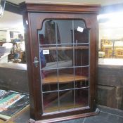 A mahogany corner cupboard