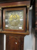 An 8-day brass face grandfather clock