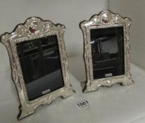A pair of silver photo frames