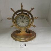 A presentation clock in the shape of a ship's wheel