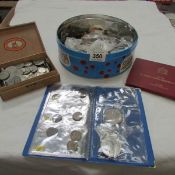 A tin of British and Foreign coins including sets