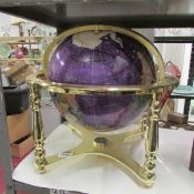 A large jewelled table globe incorporating compass