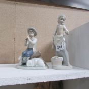 2 NAO figurines, boy with flute a/f and girl doing laundry