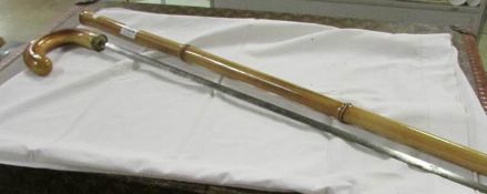 A cane swordstick with detailing to blade