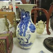 A blue and white Oriental vase depicting cranes, (small chip to the rim)
