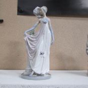 A Lladro lady in evening dress figuring a/f on right hand