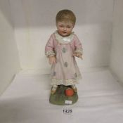 A 19th century bisque figure of a child with a ball