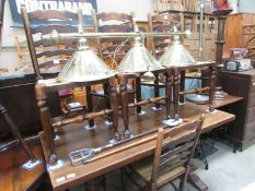 An oak refectory table and 4 ladder back chairs