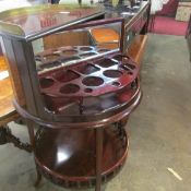 A mahogany revolving drinks cabinet/tantalus