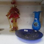 A Venetian glass figure, blue carnival glass plate and vase