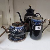 A Burslem teapot and stand, milk jug and blue overlaid coffee pot (small chip in teapot)