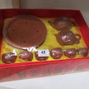 A terracotta coloured Chinese boxed tea set