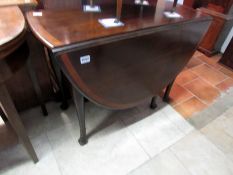 A mahogany gate leg table with tulip wood banding