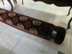 A red Turkish rug with Bokarra design, (approx. 6.5' x 4.5')