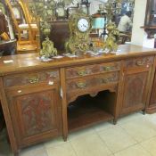An early 20th century carved mahogany sideboard base