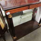 A brass inlaid console table