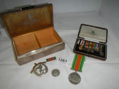 A silver cigarette box and military dress medals presented to Major H. Rodwell M.C. and other