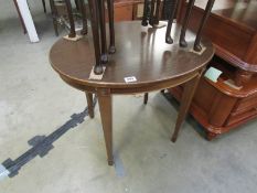 An oval table on tapered legs