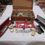 A box of costume jewellery and WW2 medal