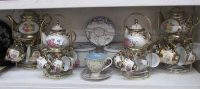 4 teasets on stands and 3 boxed cups and saucers