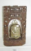 A brass temple bell in carved wood stand (35cm x 21cm)