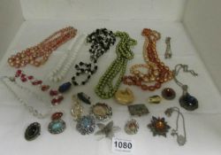 A mixed lot of costume jewellery, brooches, necklaces etc