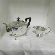 A silver plate teapot marked 'M.W. & W' and milk jug