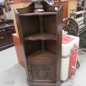 An oak corner shelf unit