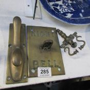 A brass hook, samovar tap and bell plate