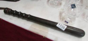 A truncheon with leather strap