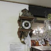 A brass and mahogany wall clock