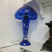 A large blue Bohemian glass table lamp