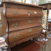 An oak 3 drawer 'Bombe' style chest