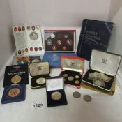 A box of mixed coin presentation sets including some pre 1947 silver coins