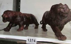 A carved wood lion and a carved wood leopard