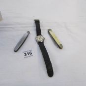 A Service wrist watch, a Service penknife and a pipe cleaner