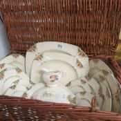 A hamper containing 22 pieces of Alfred Meakin dinnerware