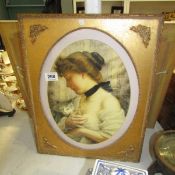 A gilt framed Pear's style print of a lady with a cat