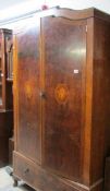 A Burr mahogany veneered wardrobe with inlaid panels