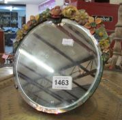 A floral decorated bevelled mirror