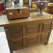 An oak sideboard with carved back reading 'We love The Place O God'